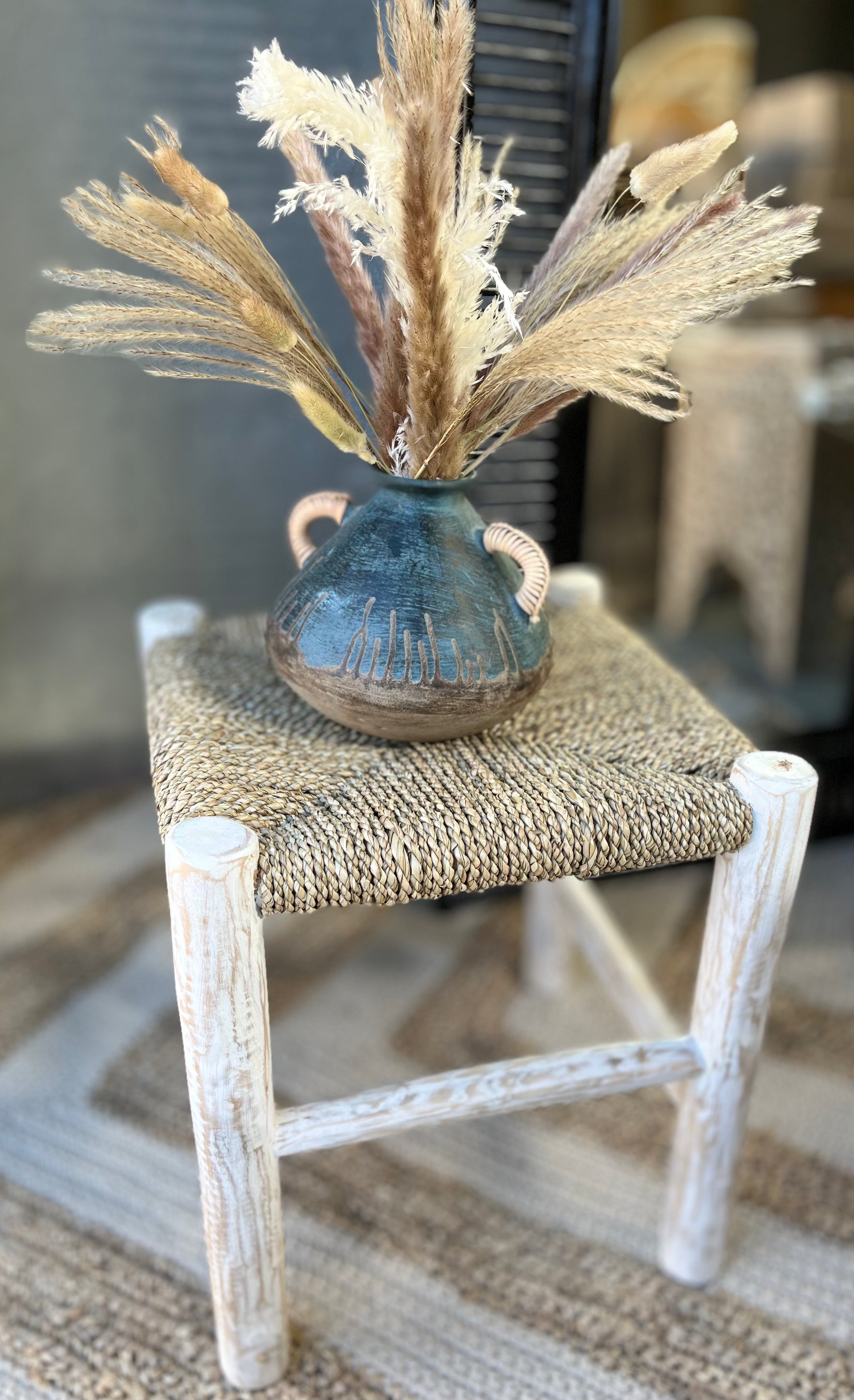 Square natural woven stool /side table with white timber legs.