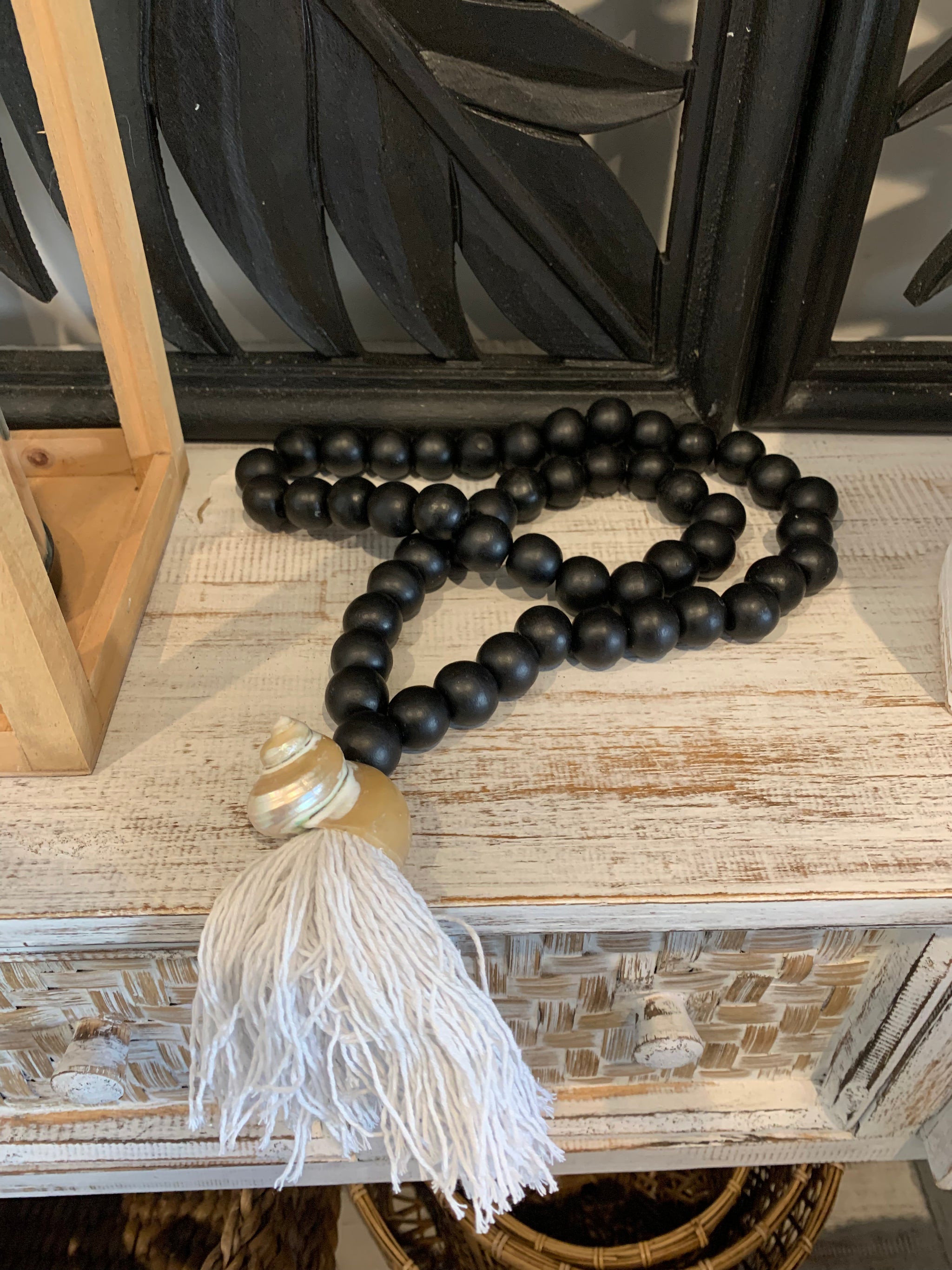 Black bead necklace / tassel decoration with shell detail and white tassel. - Bali Beach Beyond