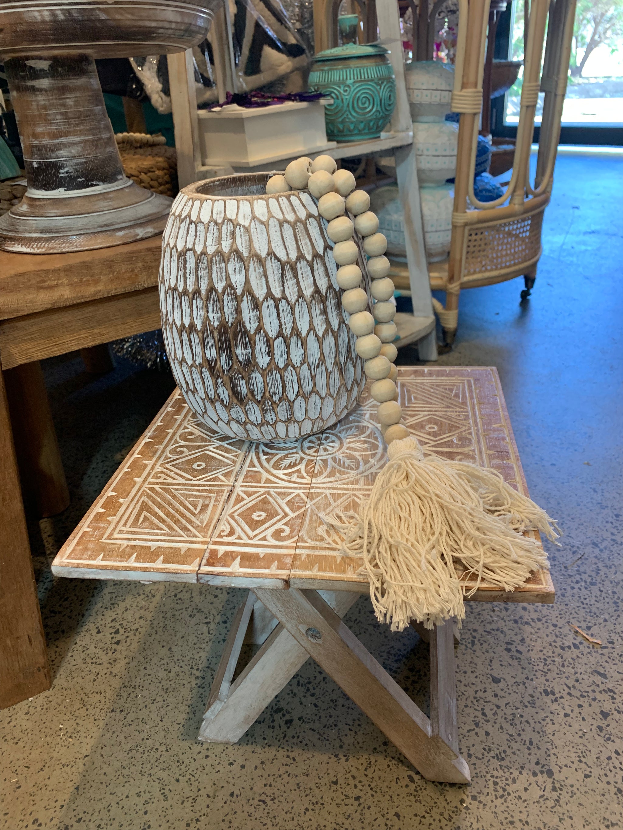 Folding timber carved design table. Natural finish.