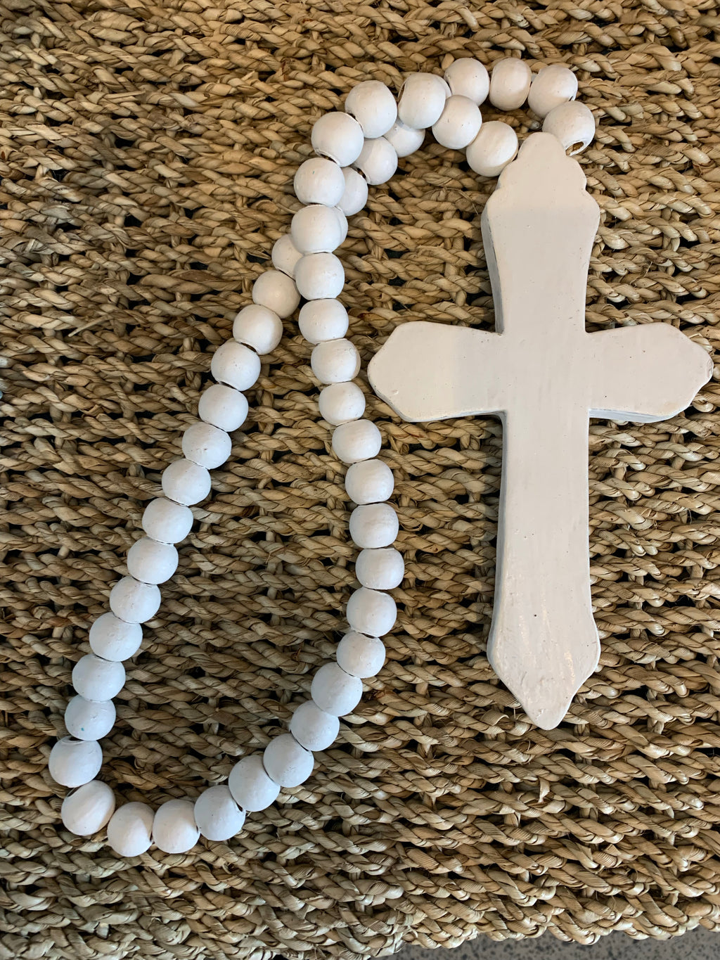 Rustic white timber cross with white beads. - Bali Beach Beyond