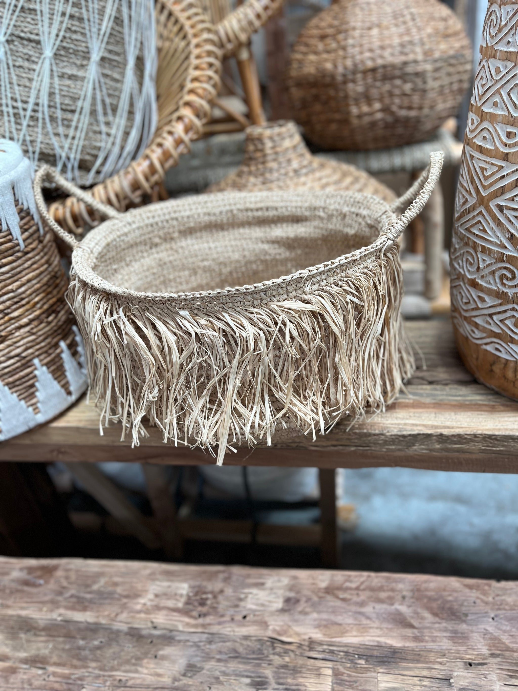 Woven basket with raffia trim detail