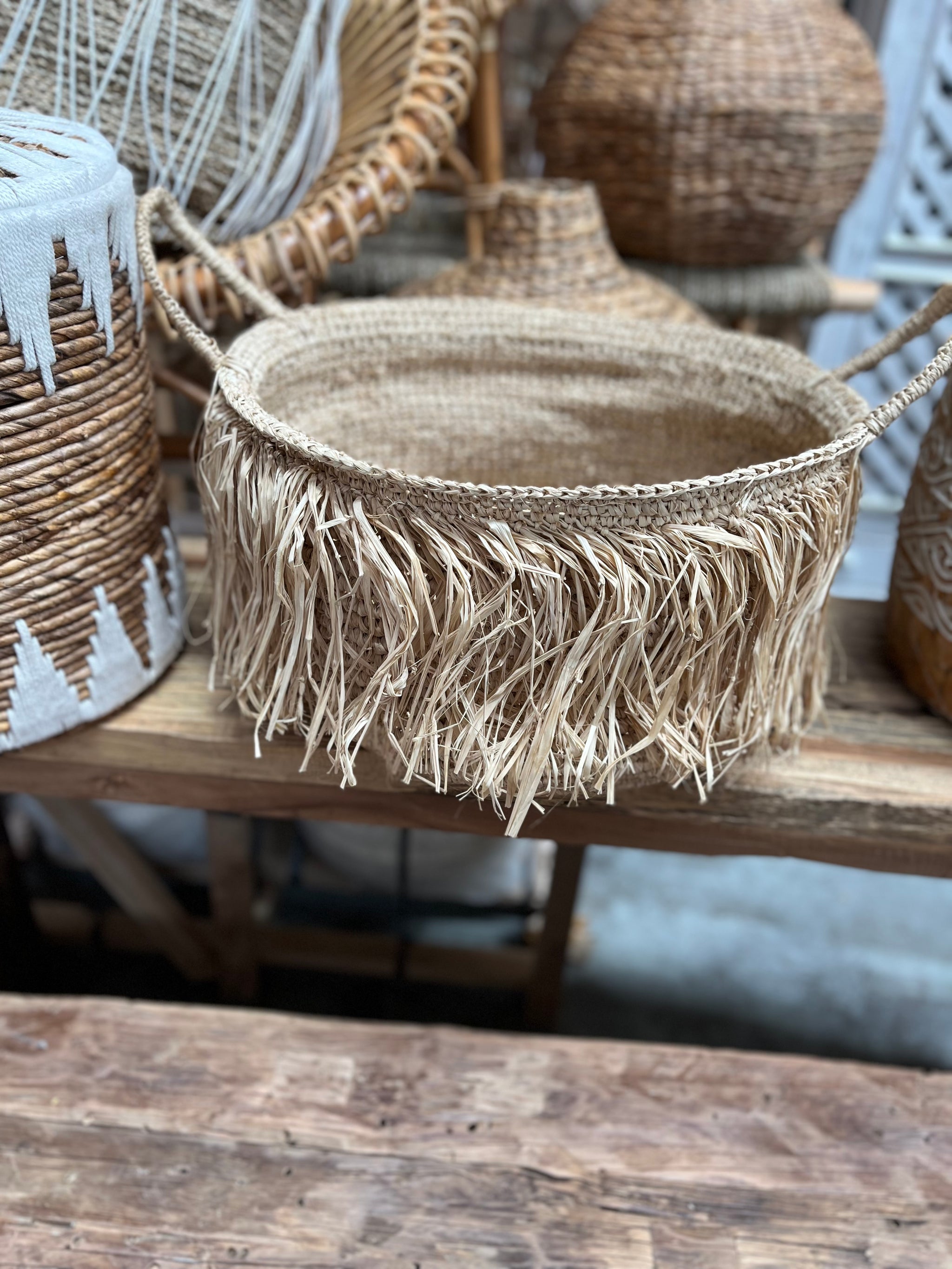 Woven basket with raffia trim detail