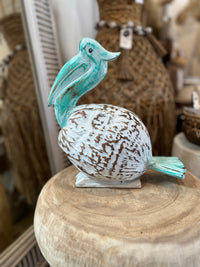 Coconut Pelican on stand. Turquoise/ white