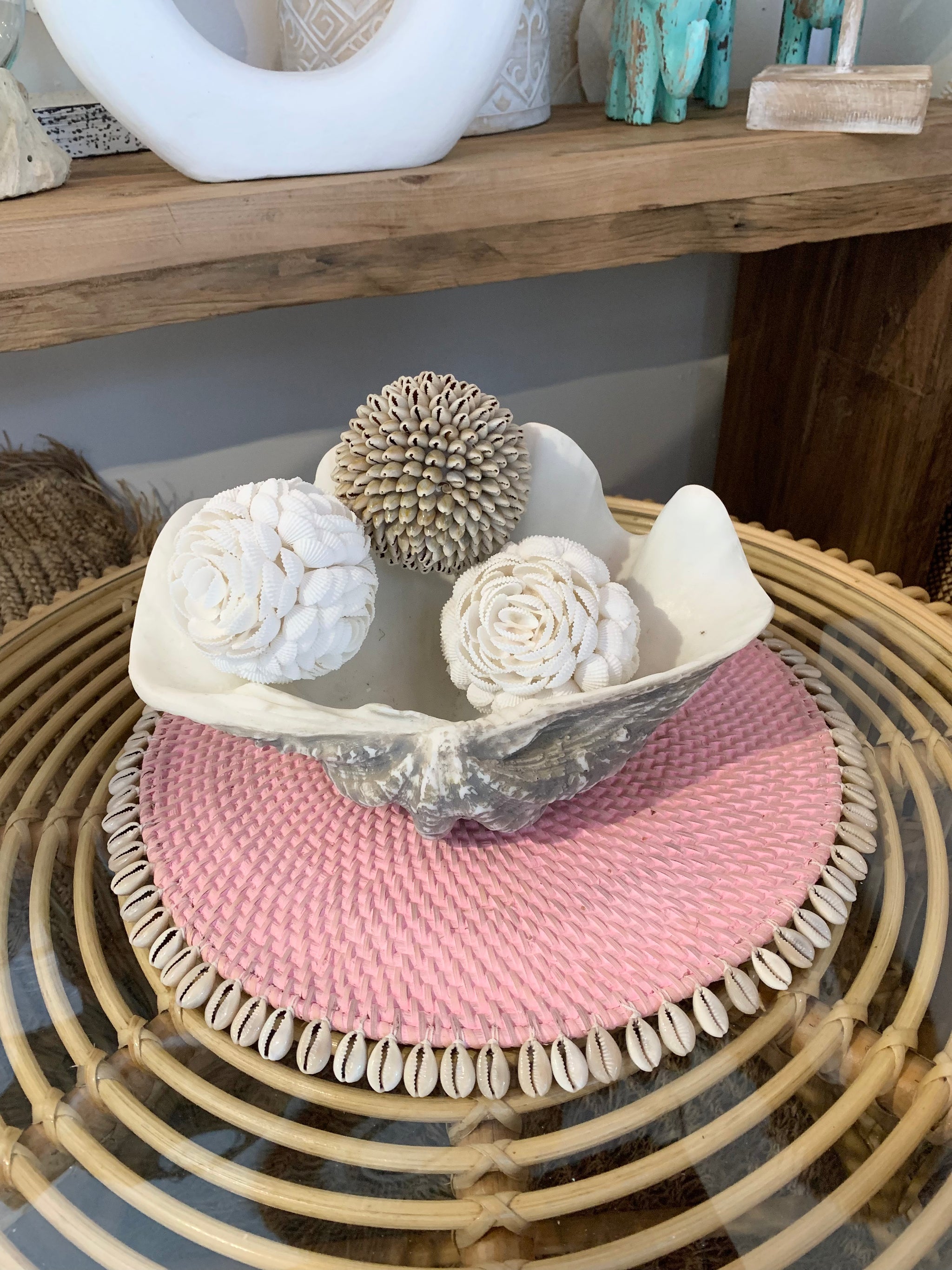 Pink rattan placemat with cowrie shells