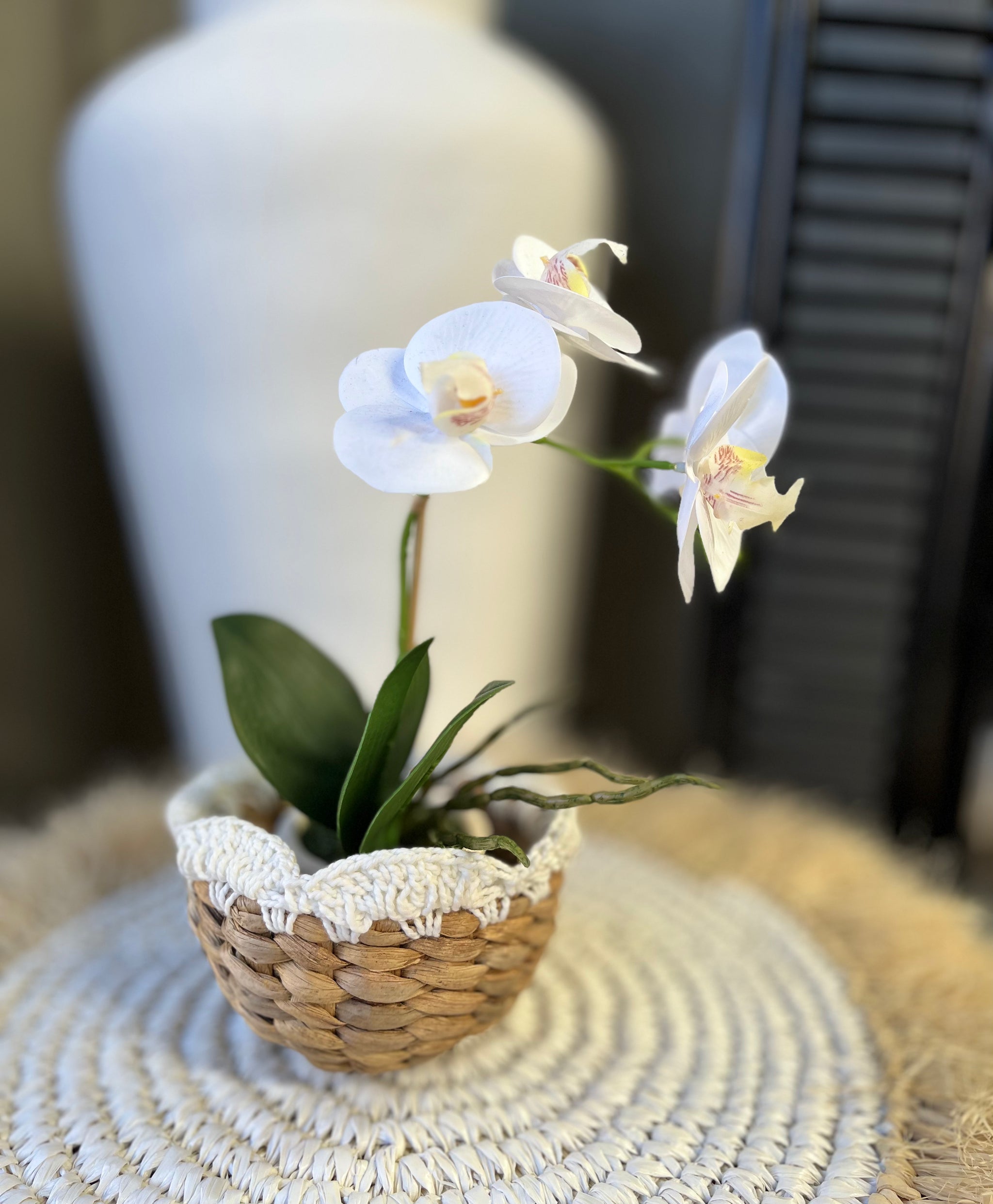 Woven basket with macrame detail at top