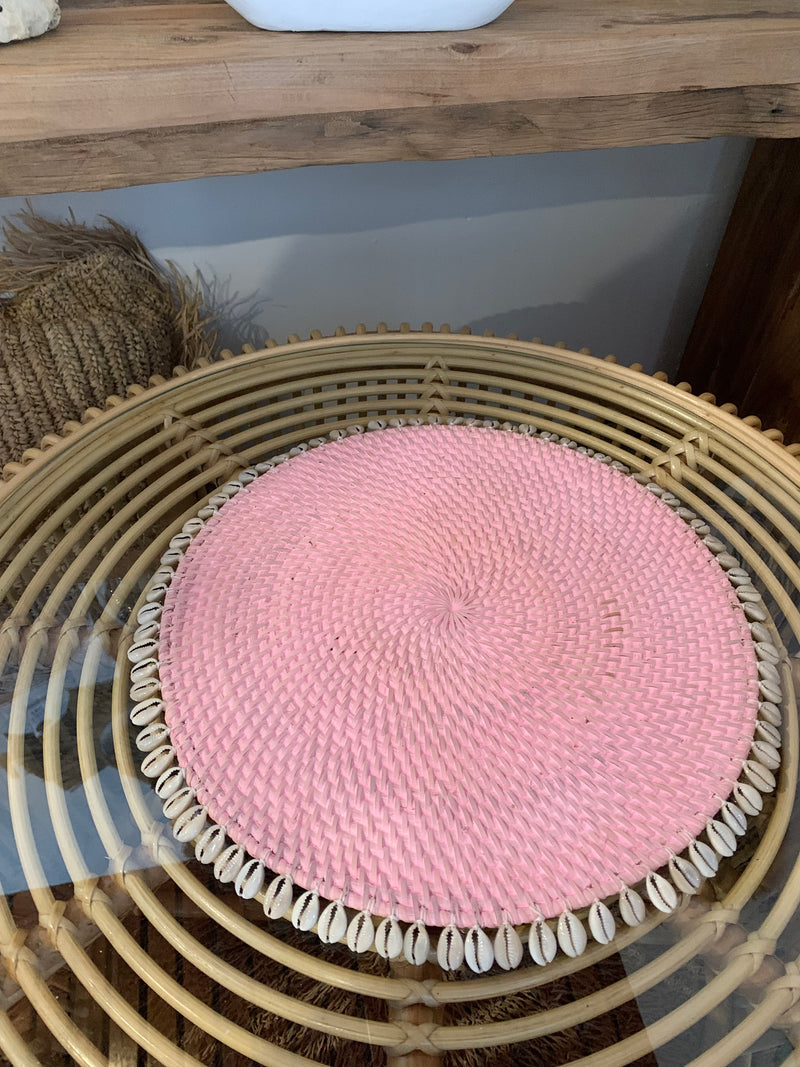 Pink rattan placemat with cowrie shells