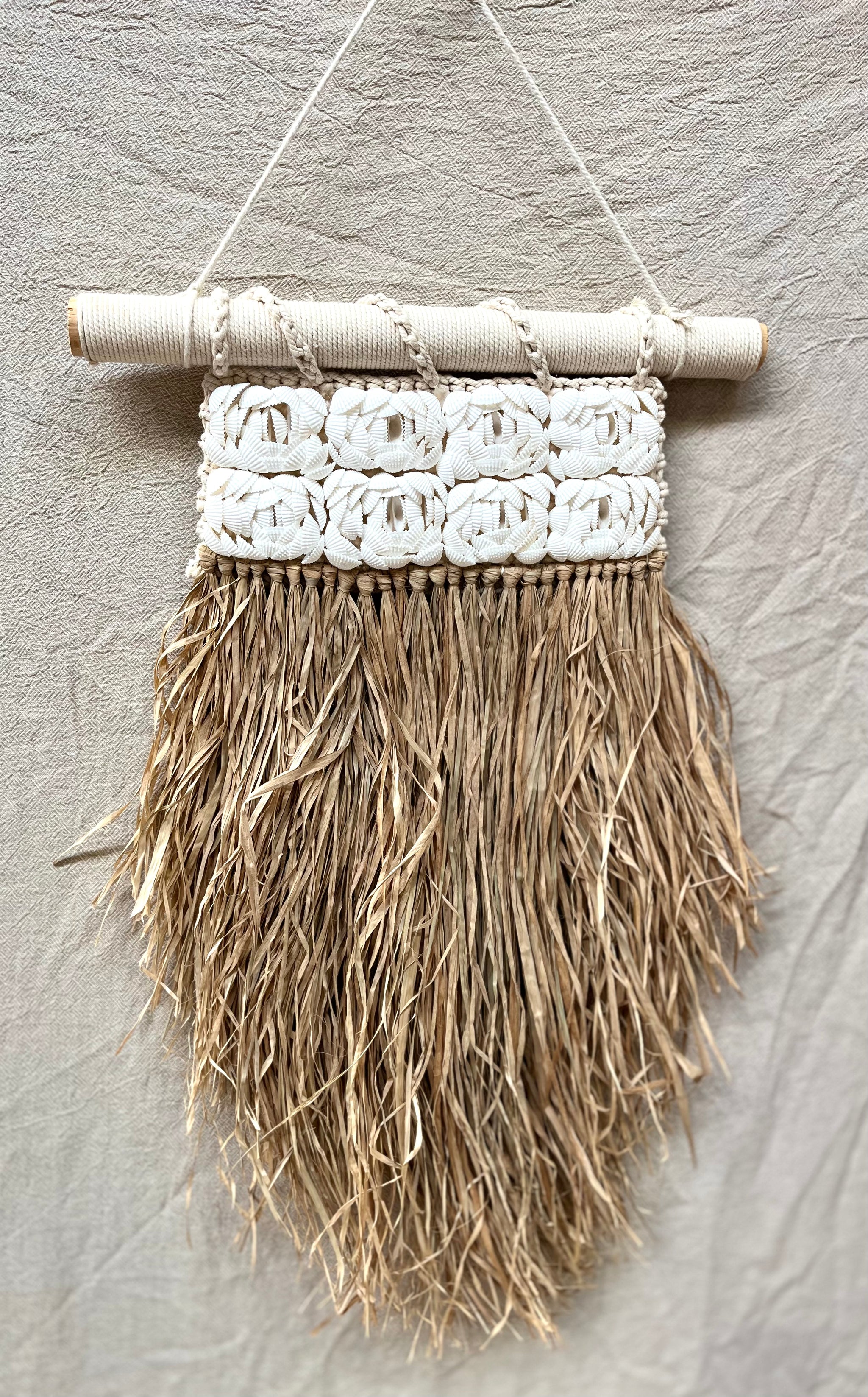 Shell and raffia wall hanging.