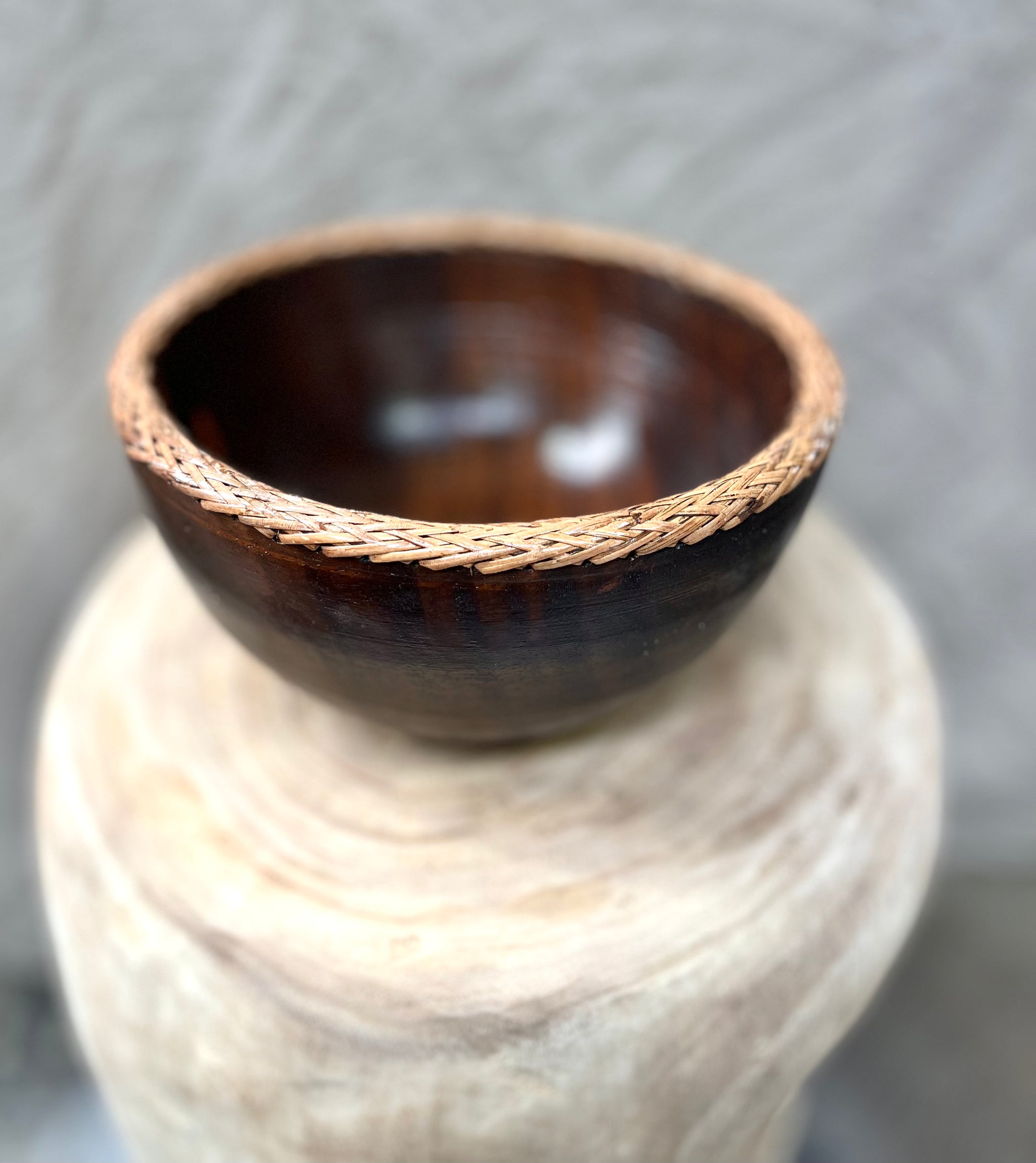 Brown timber bowl with rattan edge detail. M