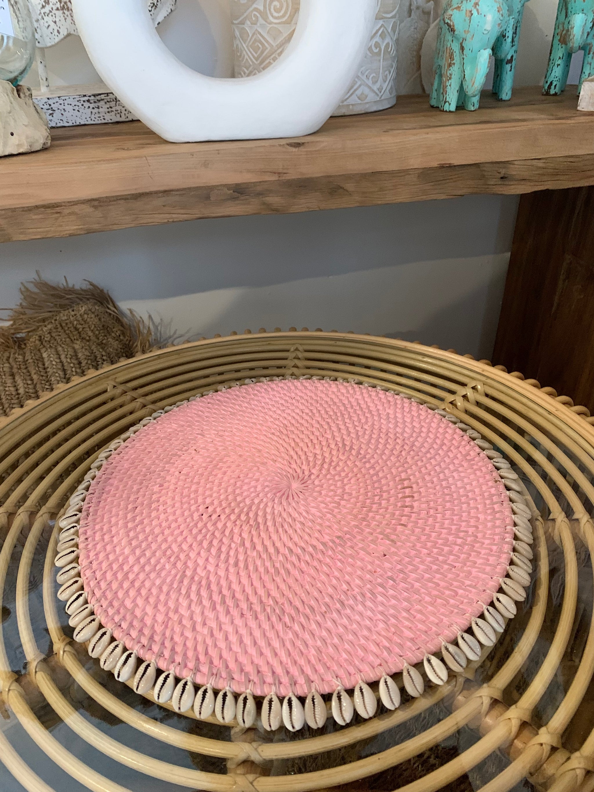 Pink rattan placemat with cowrie shells