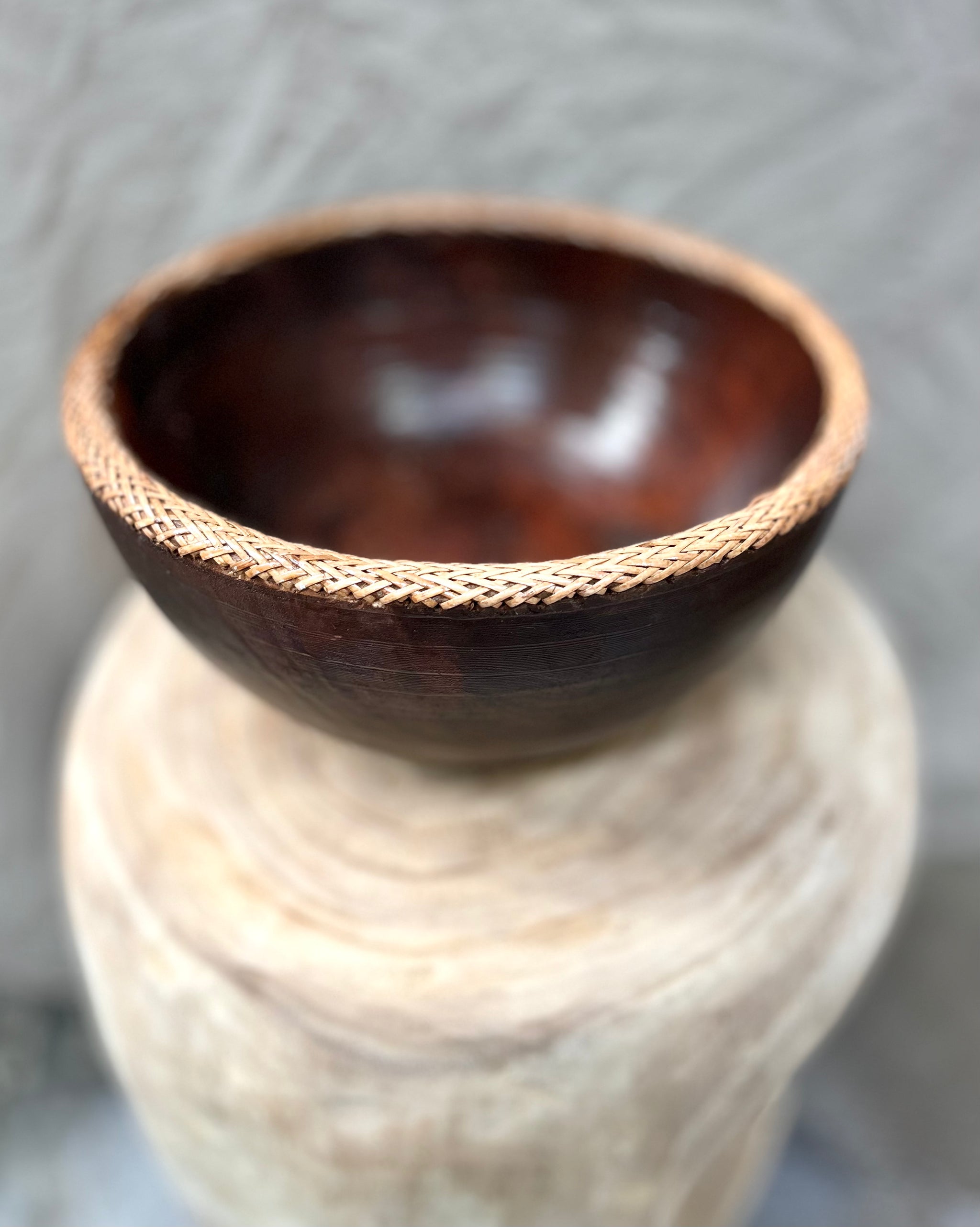 Brown timber bowl with rattan edge detail. L