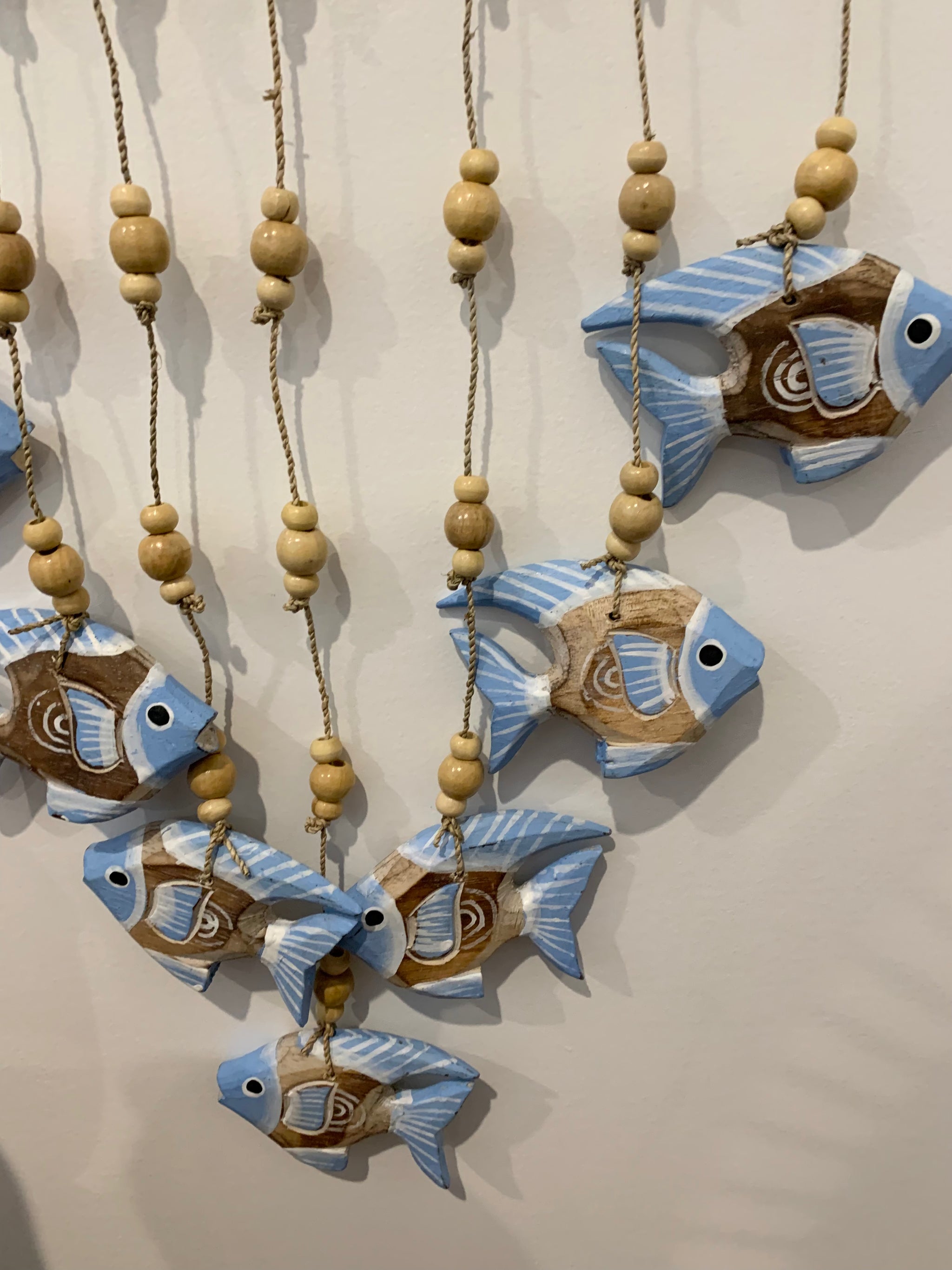 Blue carved timber fish wall hanging.