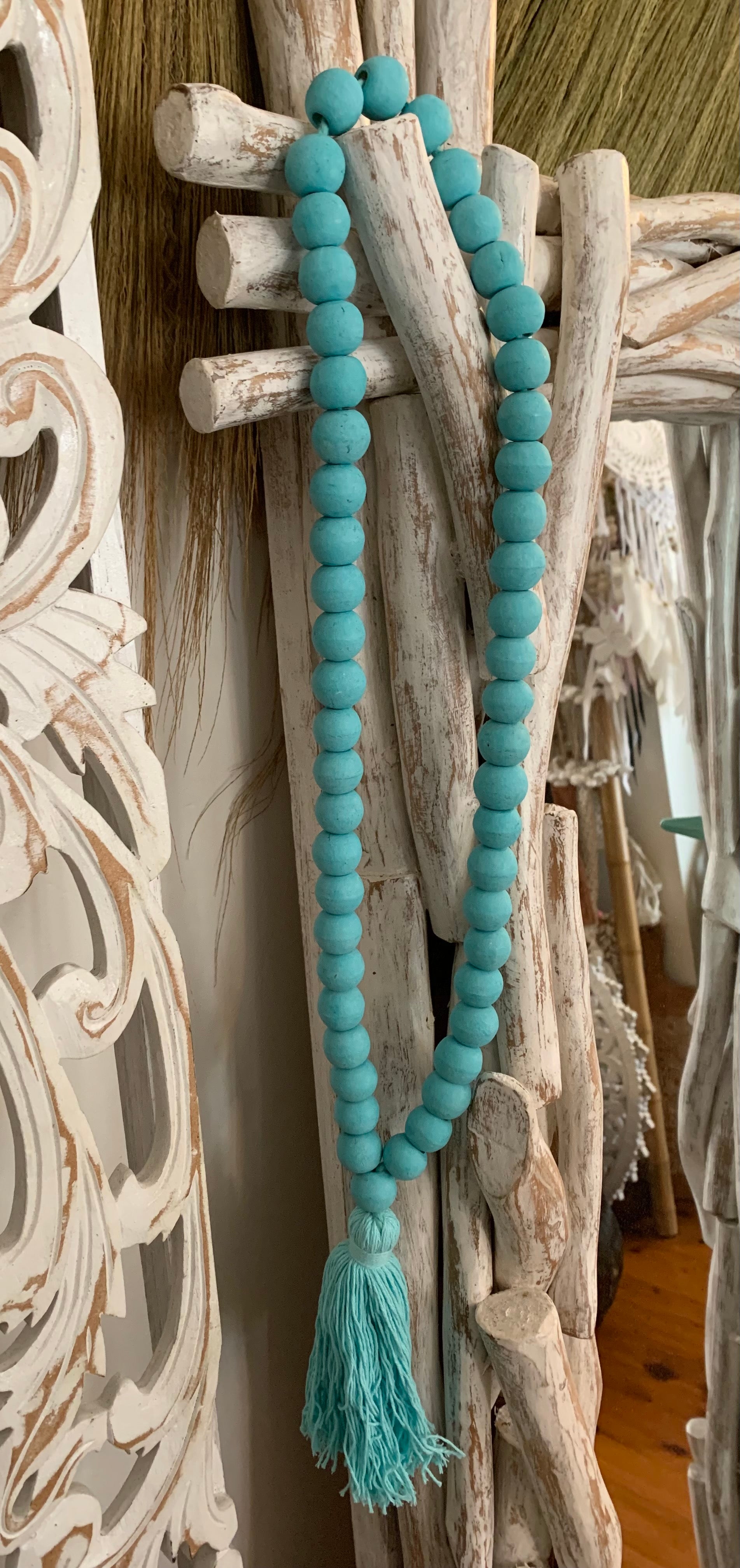 Turquoise timber beads and tassel.