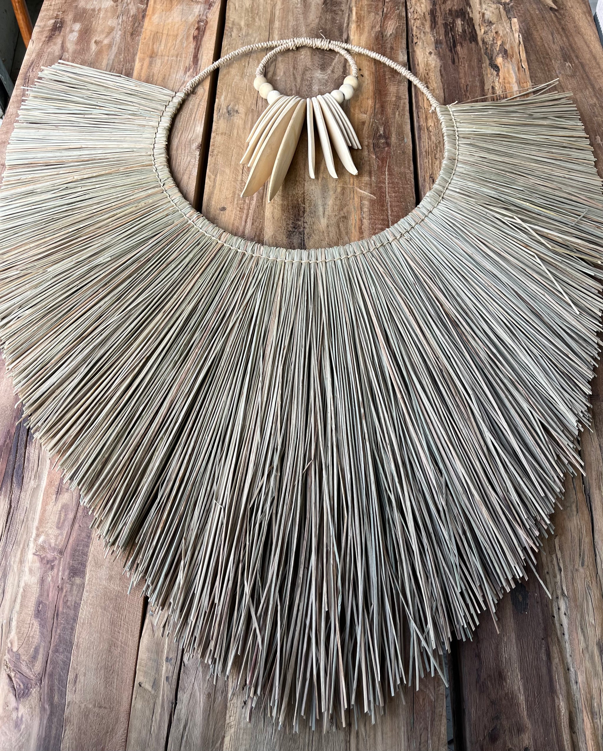 Raffia and natural timber wall hanging