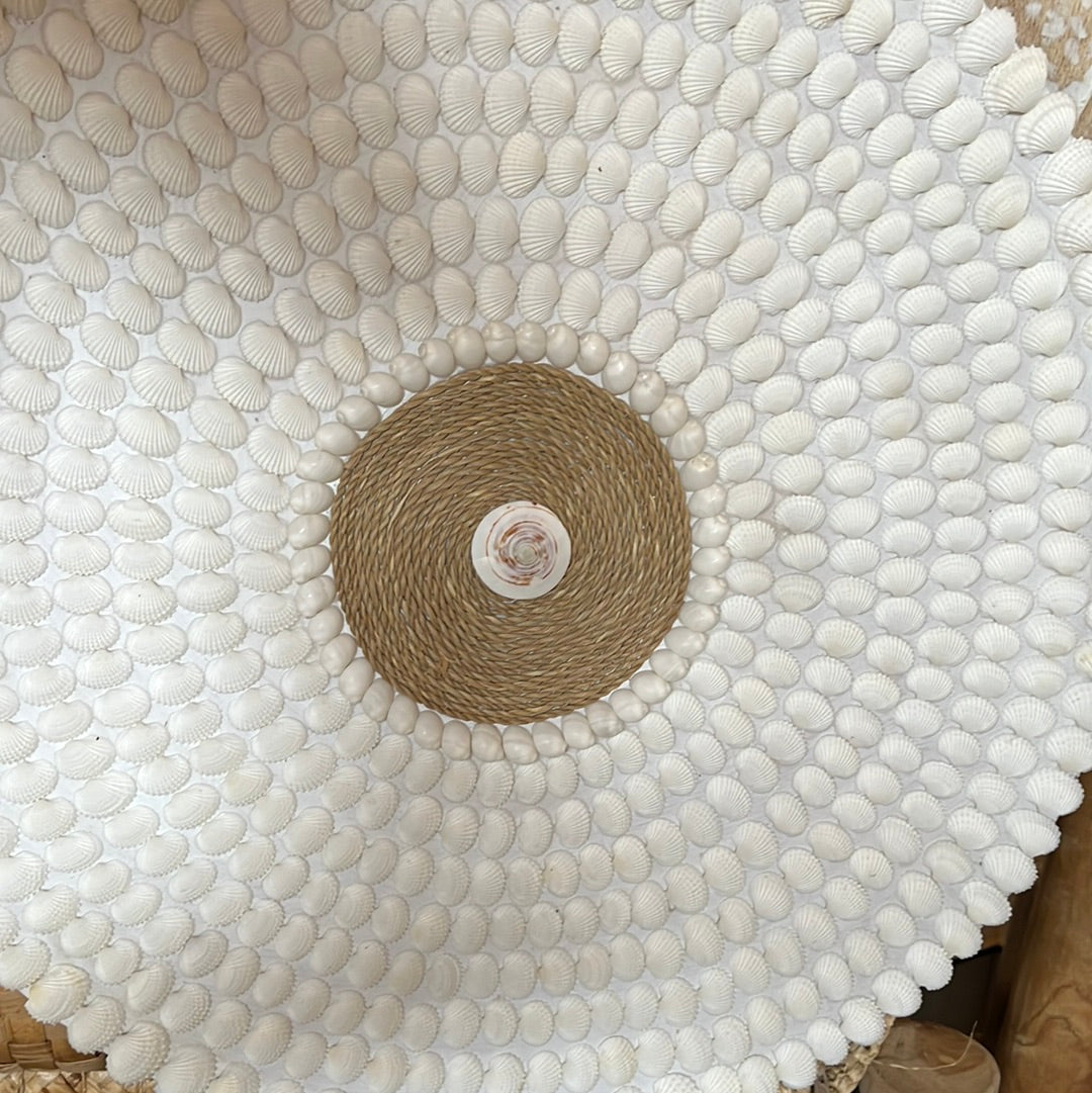 Round detailed shell wall hanging.