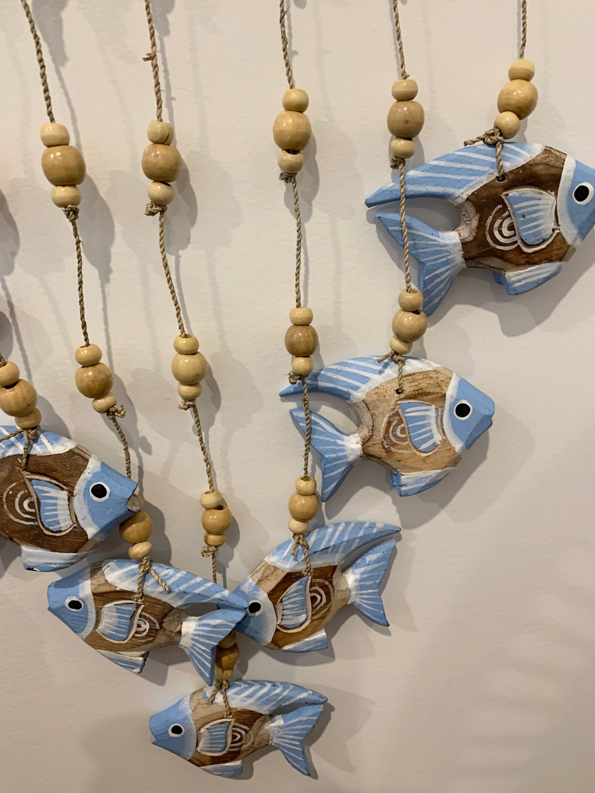 Blue carved timber fish wall hanging.