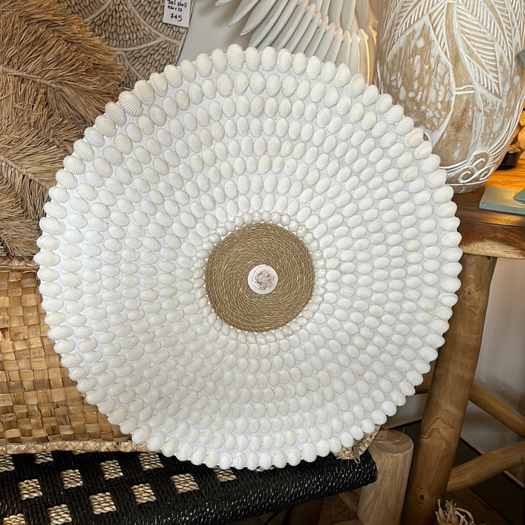 Round detailed shell wall hanging.