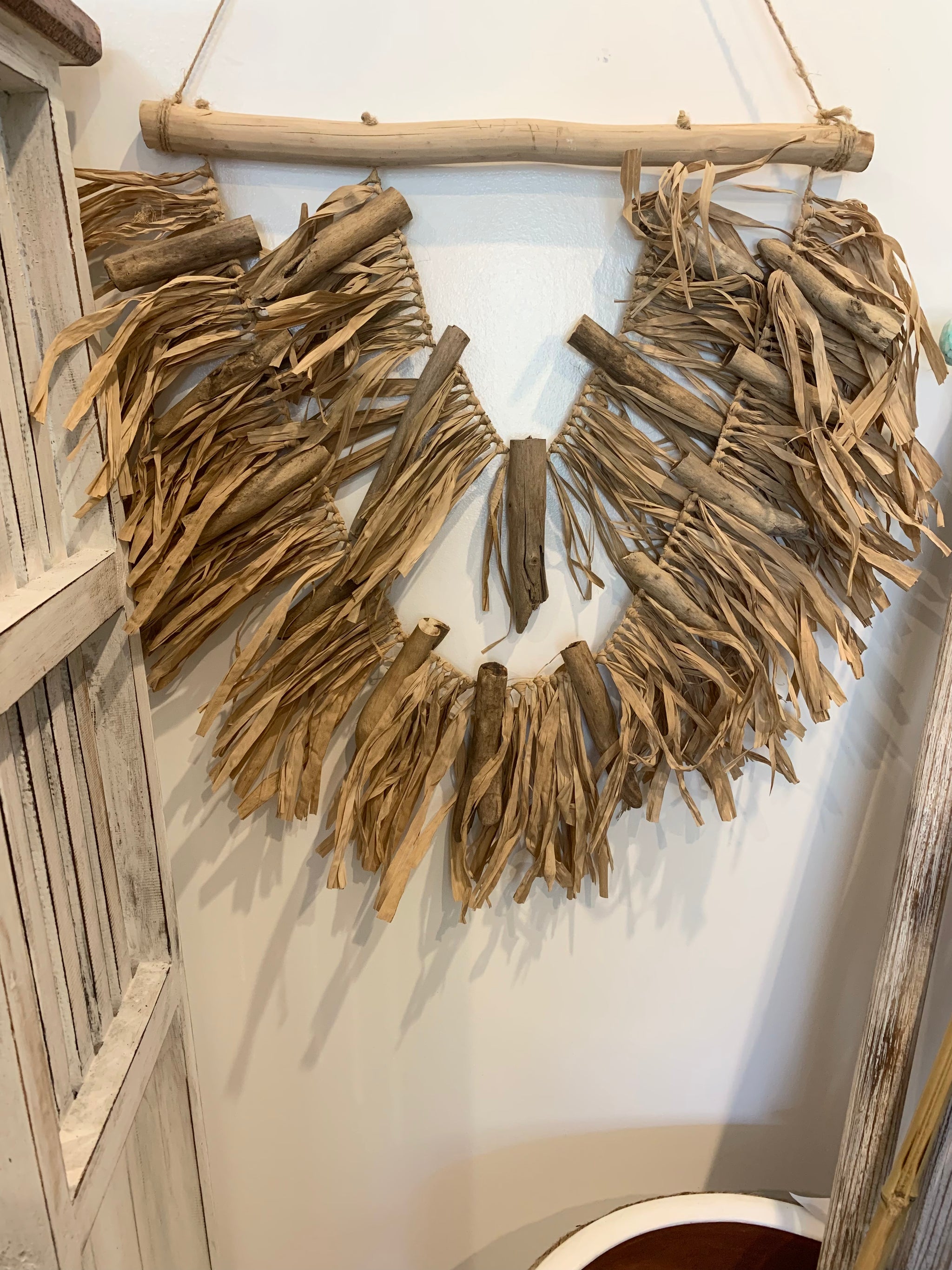 Raffia and timber wall hanging