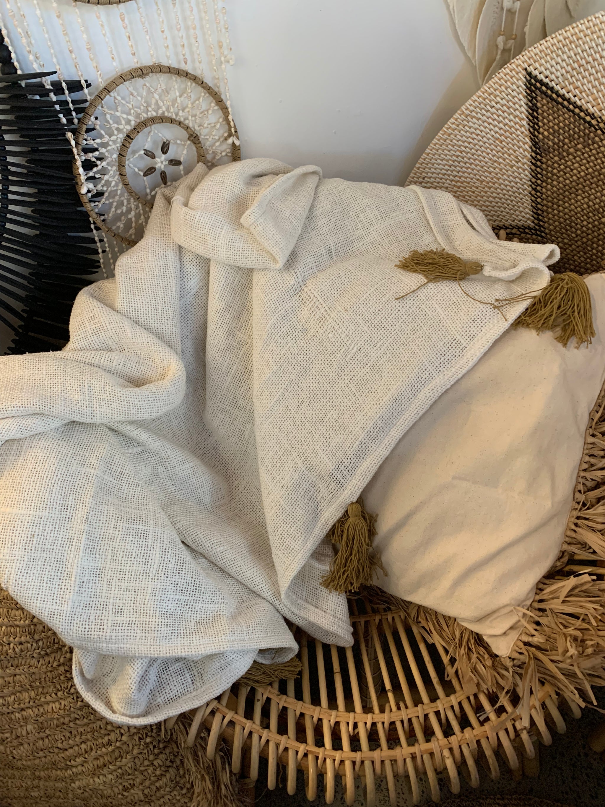 Natural throw with brown tassels