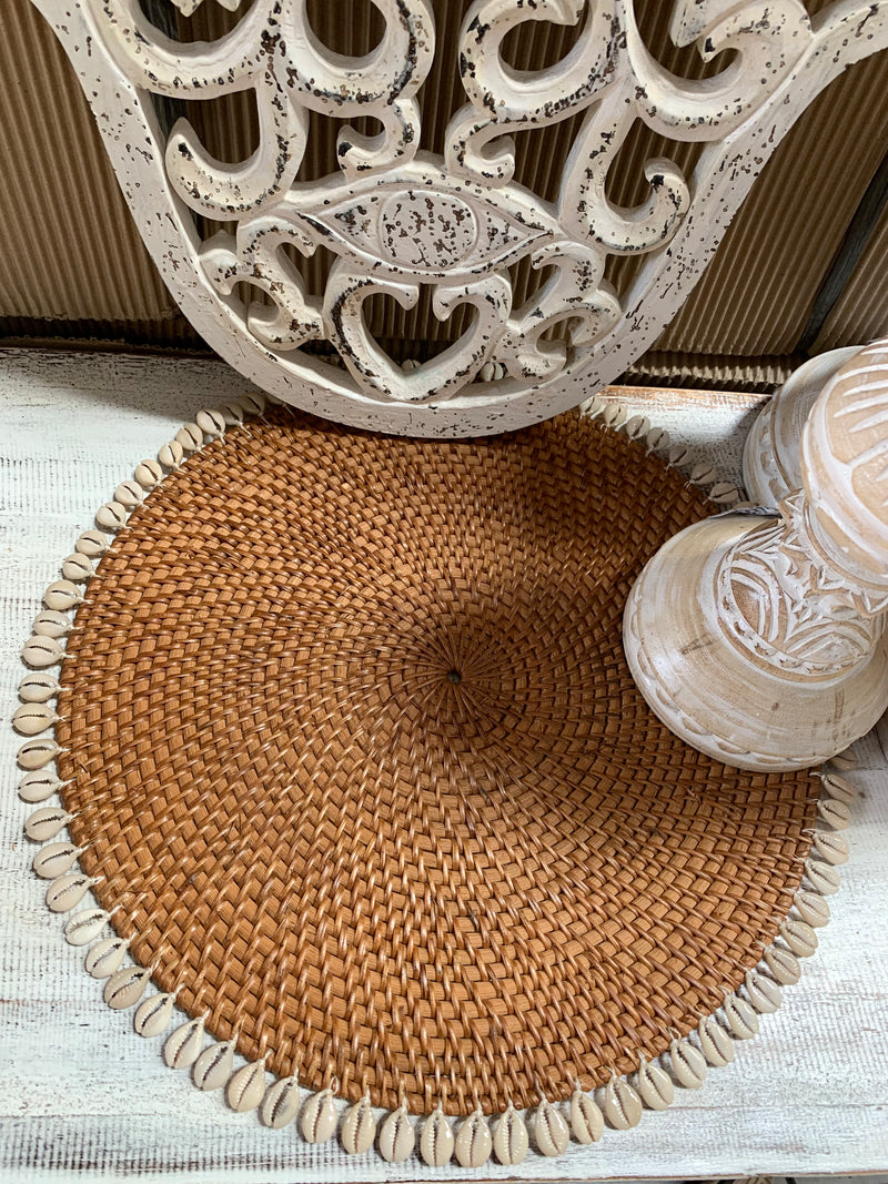 Natural rattan placemat with cowrie shells