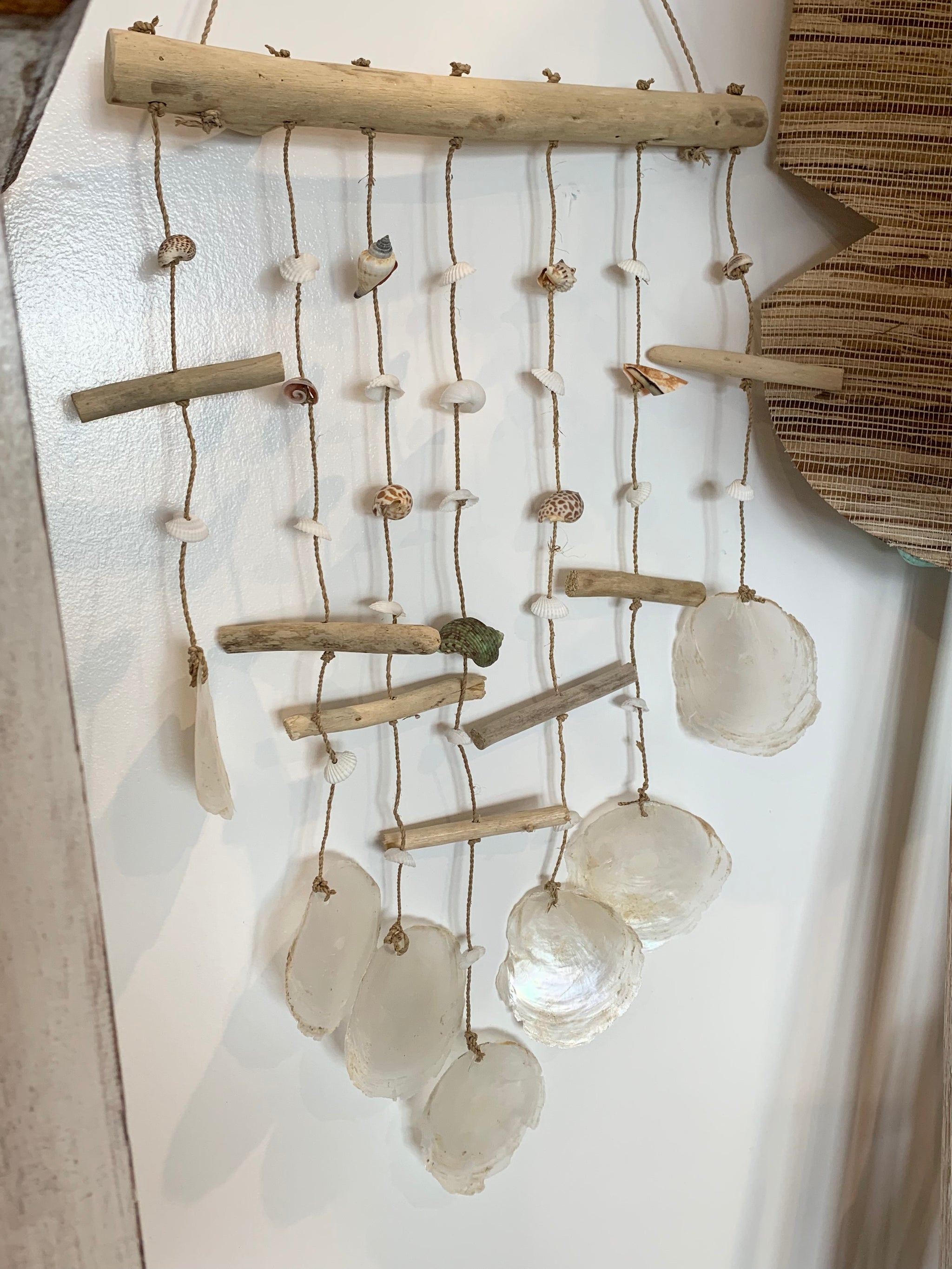 Shell wall hanging on timber stick