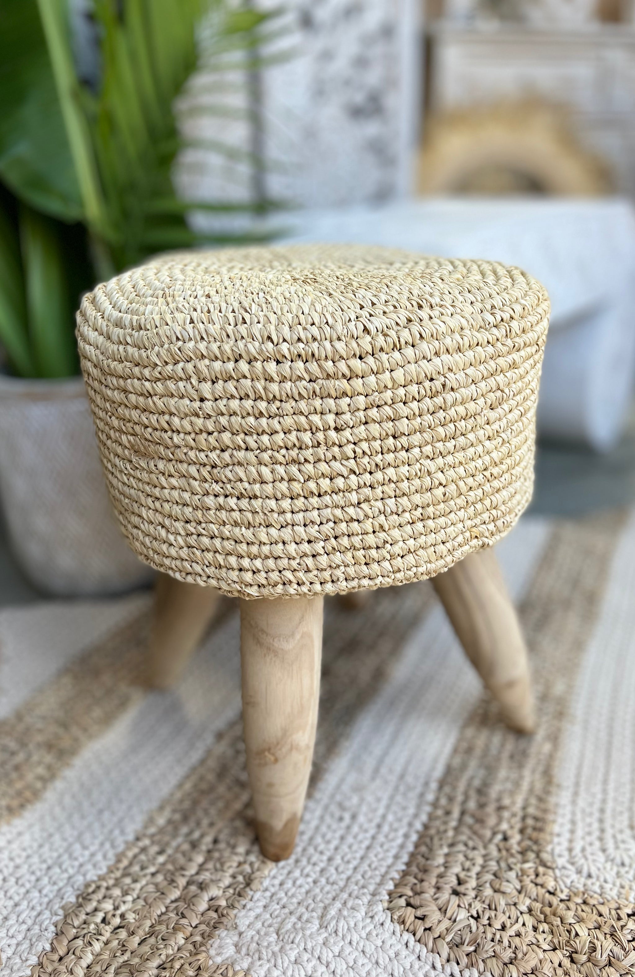 Round woven stool with timber legs.