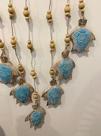 Aqua blue carved timber turtle wall hanging.